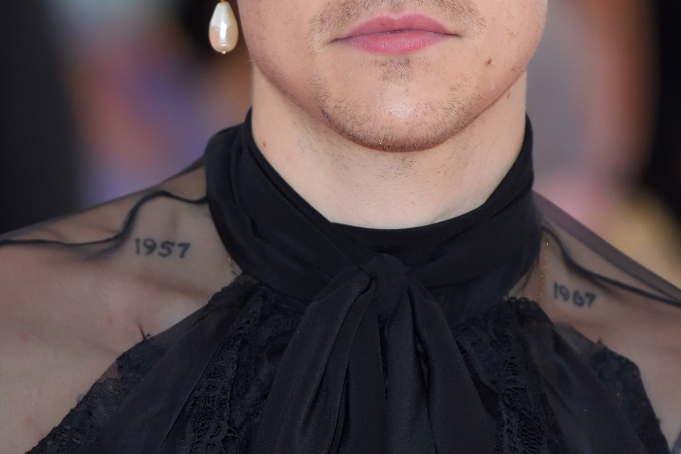 Harry Styles’s 1957 and 1967 collarbone tattoos, reported as his parents’ birth years