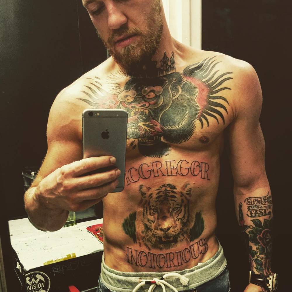 Conor McGregor MCGREGOR and NOTORIOUS lettering tattoo on his midsection