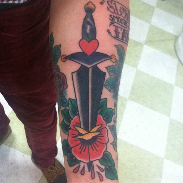 Conor McGregor dagger and rose tattoo on his forearm