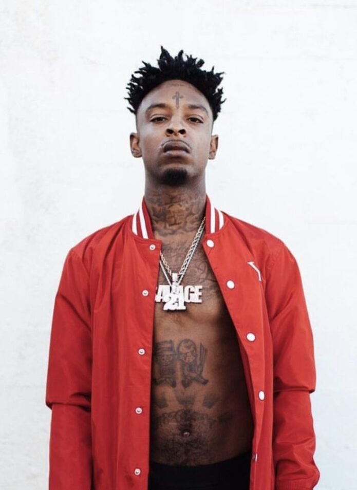 21 Savage showing his face tattoo symbols in a close portrait