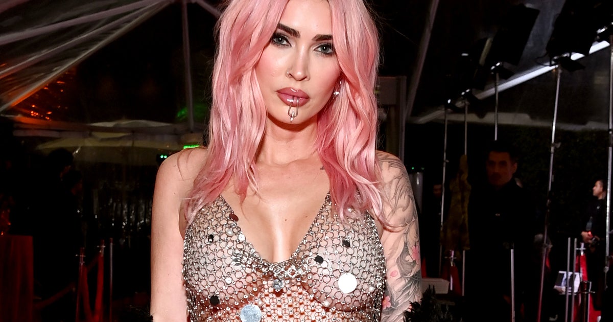 Megan Fox showing later arm and chest tattoos