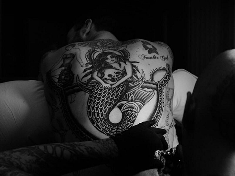 Adam Levine during a session for his large mermaid back tattoo