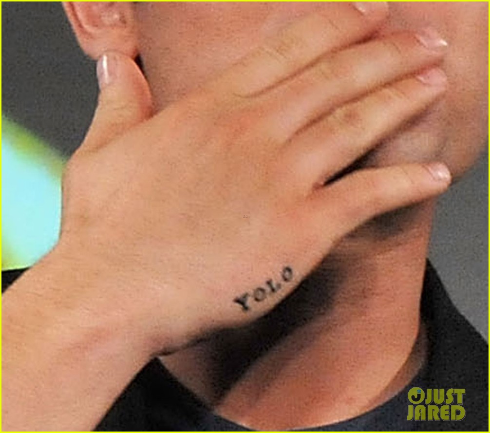 Close view of Zac Efron’s YOLO tattoo on his right hand