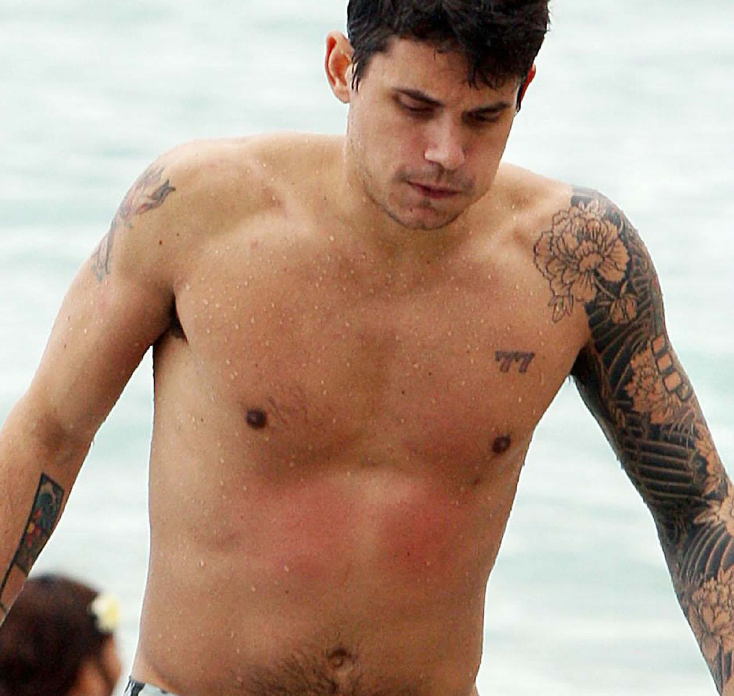 John Mayer’s 77 chest tattoo, visible between the shoulders