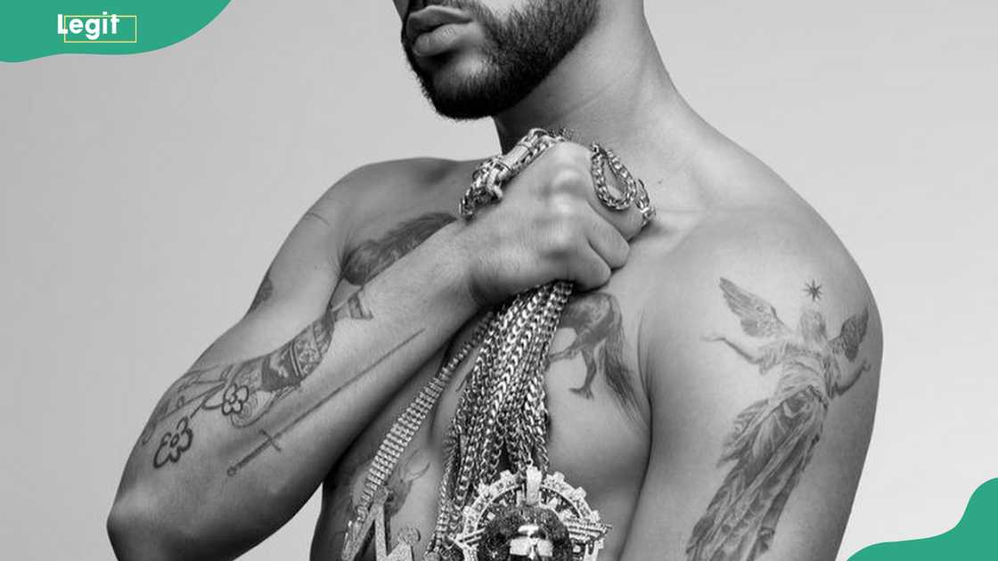 Bad Bunny tattoos: Bad Bunny sword and angel arm tattoos