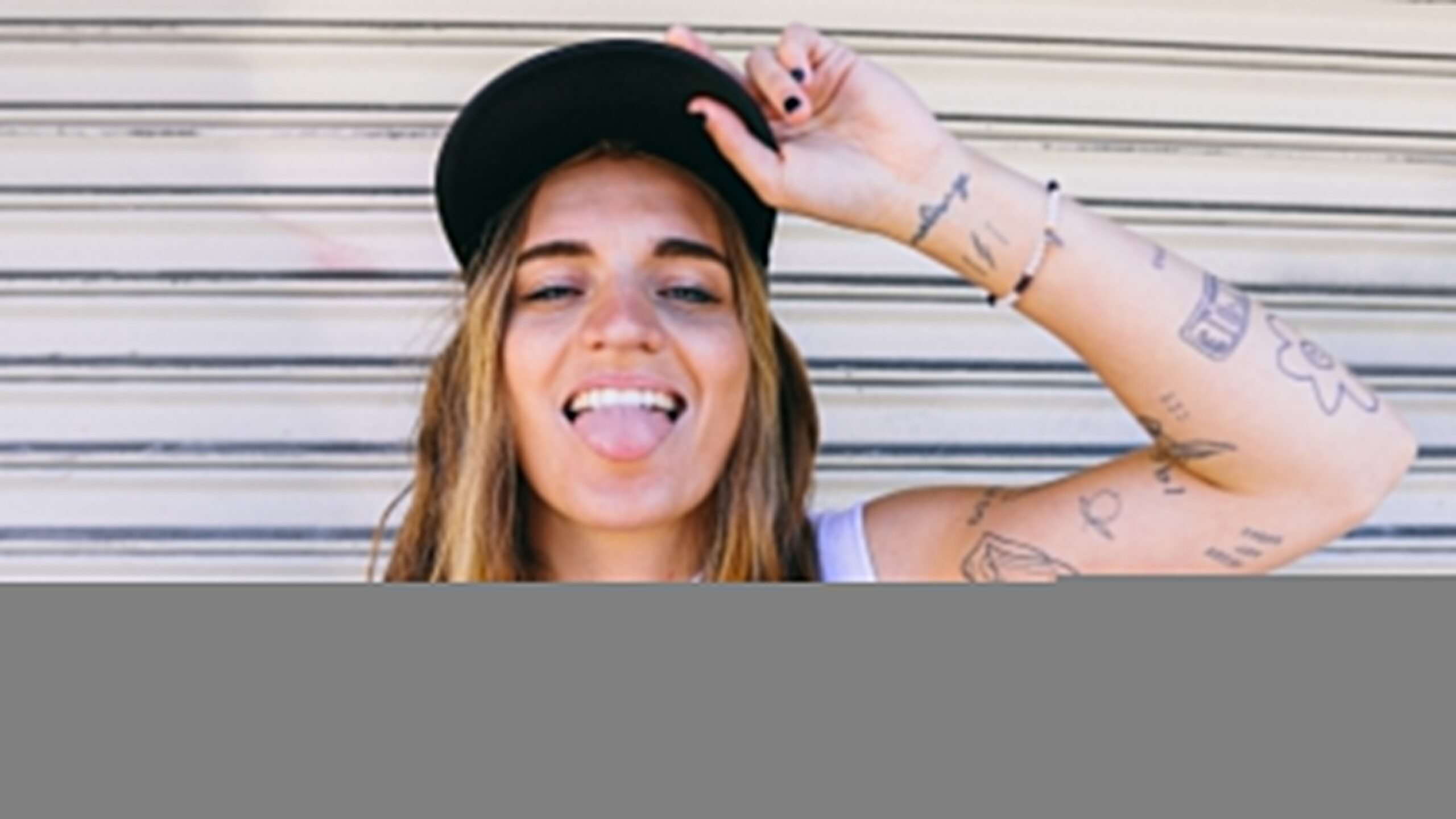 G Flip tattoos: high-resolution arm portrait showing multiple linework and lettering tattoos