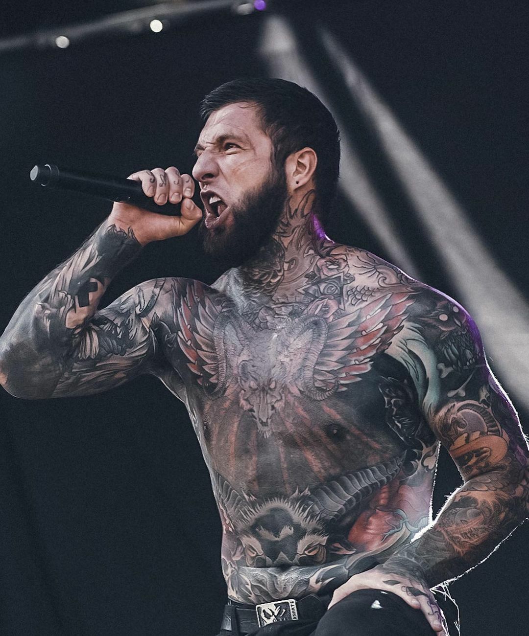 Alex Terrible winged skull chest and arm tattoos