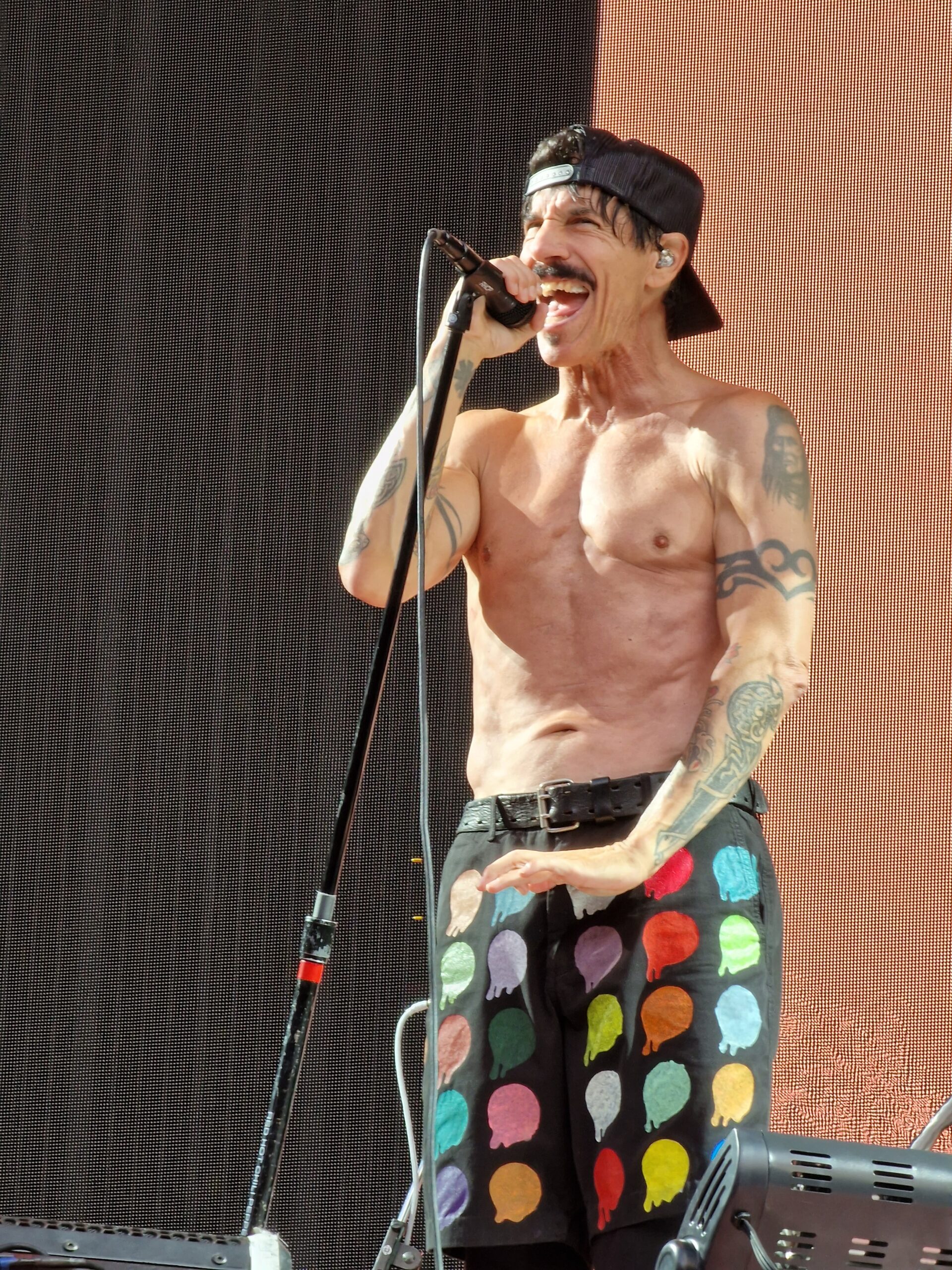 Anthony Kiedis shirtless showing torso, shoulder and arm tattoos