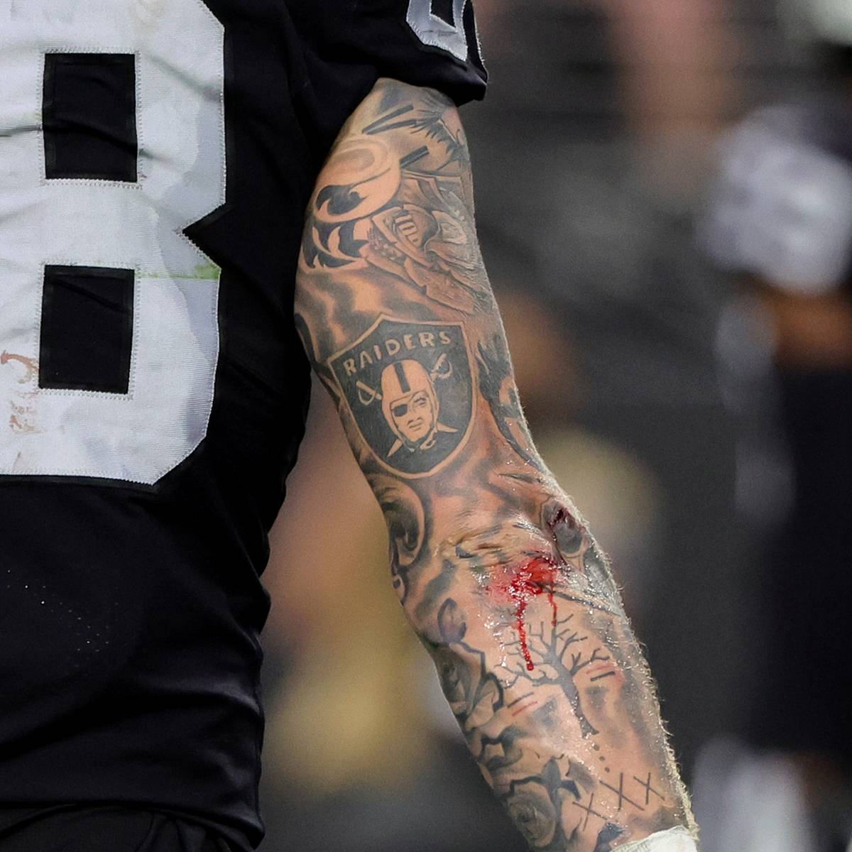 Maxx Crosby tattoos: Raiders sleeve tattoo