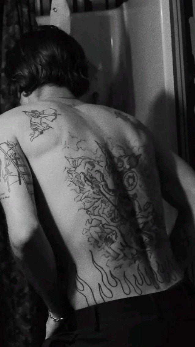 Damiano David tattoos: Large back tattoo with wings and dark illustrative linework