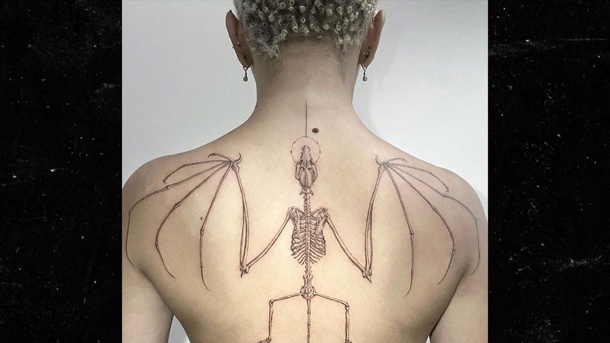 Doja Cat tattoos: large clear view of Doja Cat’s bat skeleton back tattoo