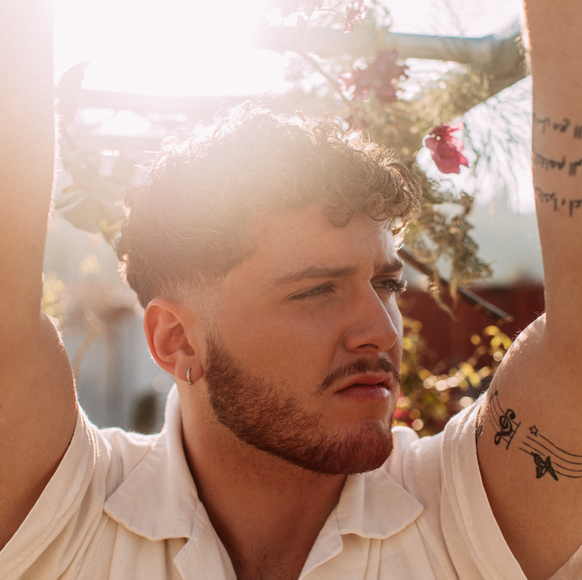 Bazzi musical note arm tattoos