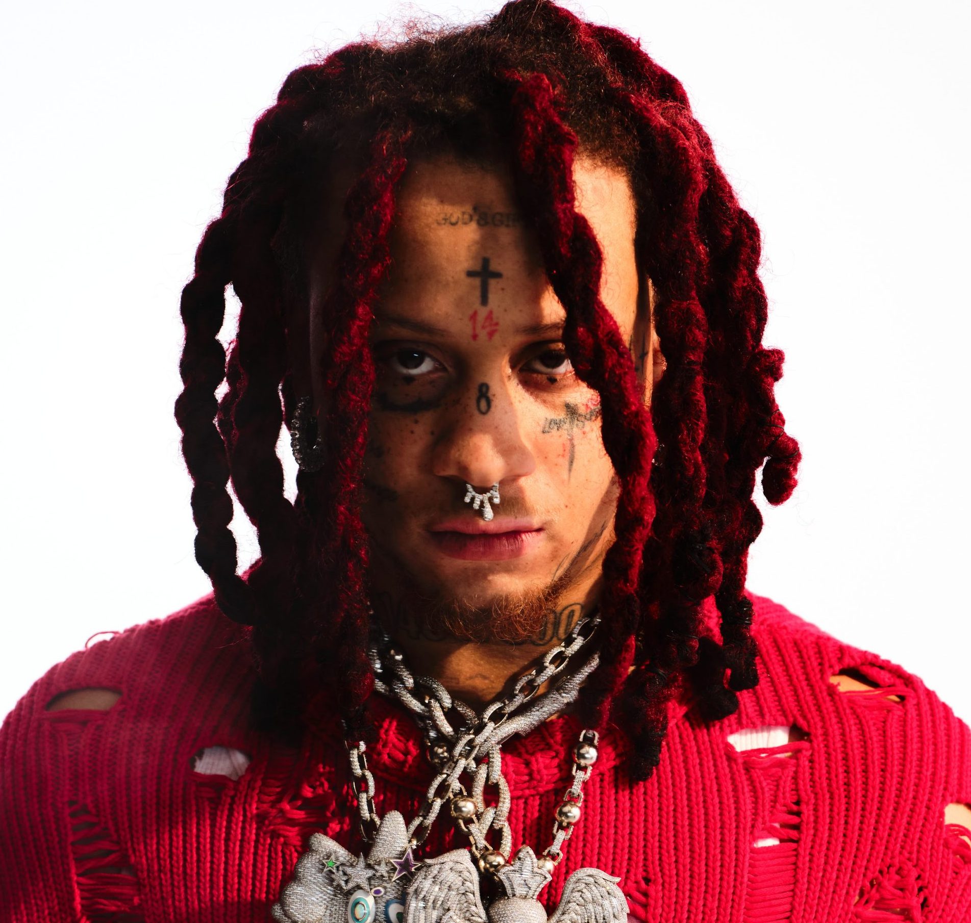 Trippie Redd tattoos: separate portrait showing the neck numbers and lower-face lettering