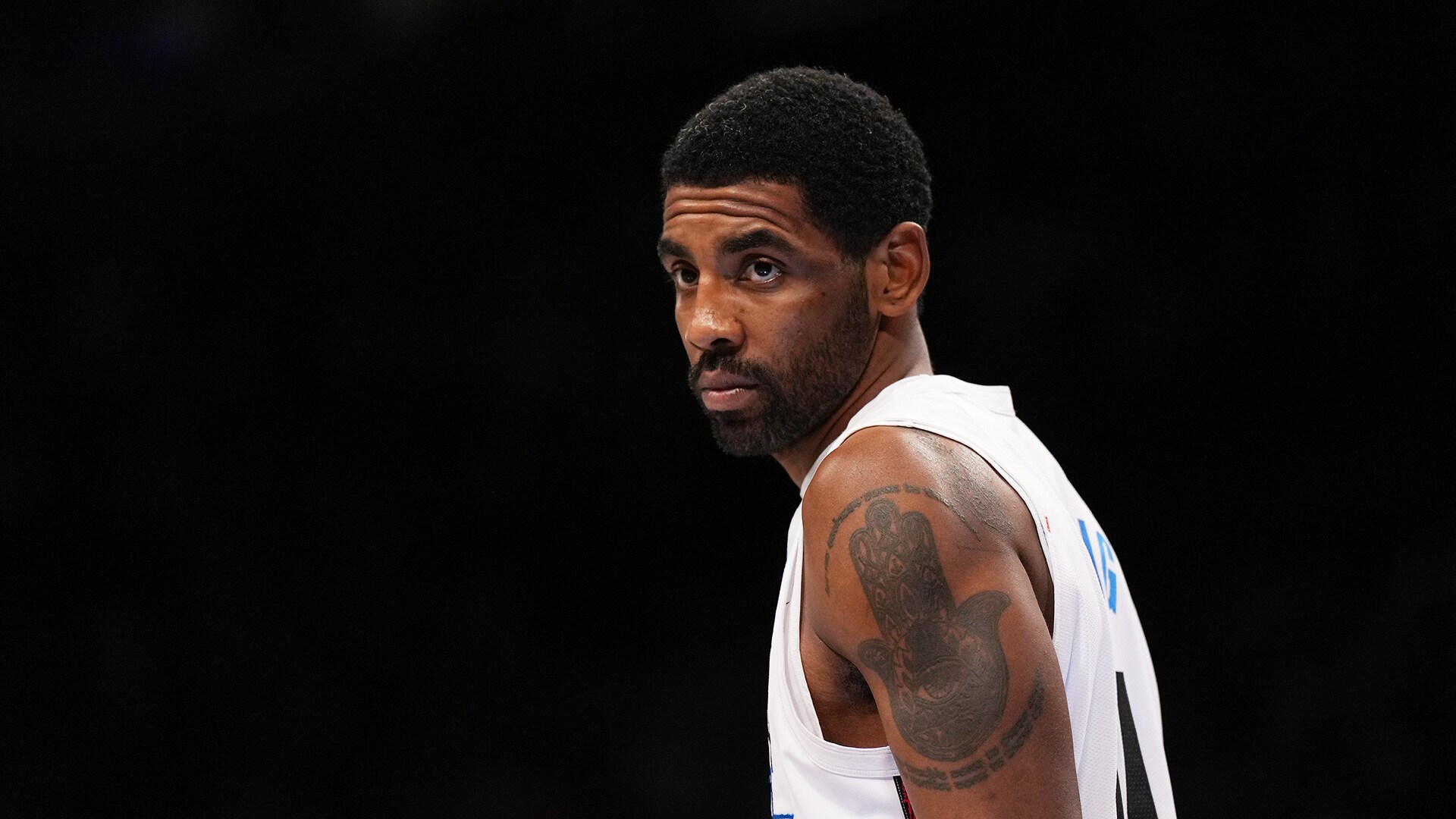 Kyrie Irving tattoos: high-resolution game photograph showing the upper-arm work and placement beneath a jersey