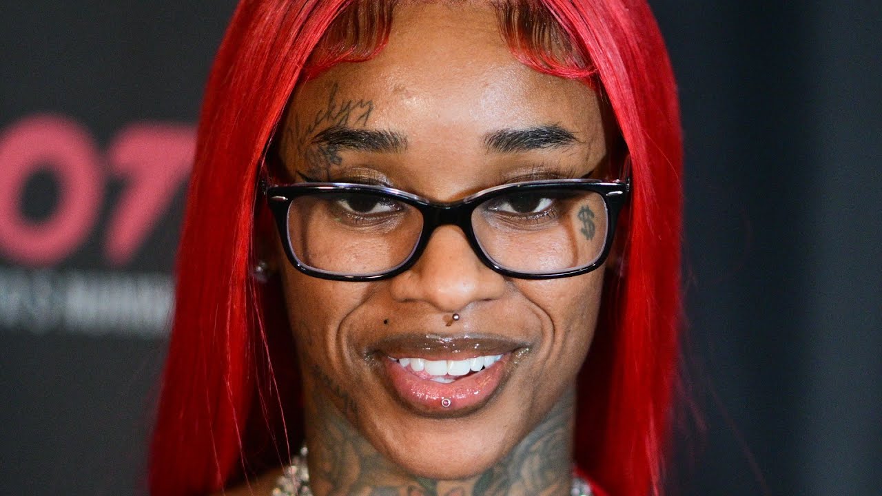 Sexyy Red tattoos: close-up showing the dollar sign and forehead lettering