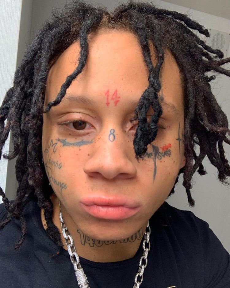 Trippie Redd tattoos: separate close-up showing the LOVE SCARS lettering and cheek ink
