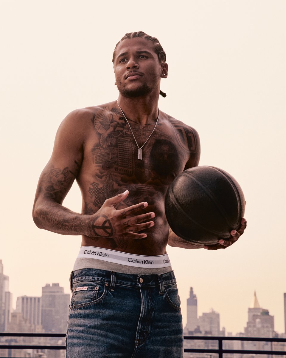 Jalen Green tattoos: different rooftop photograph showing the chest, ribs and arm tattoos from a wide angle