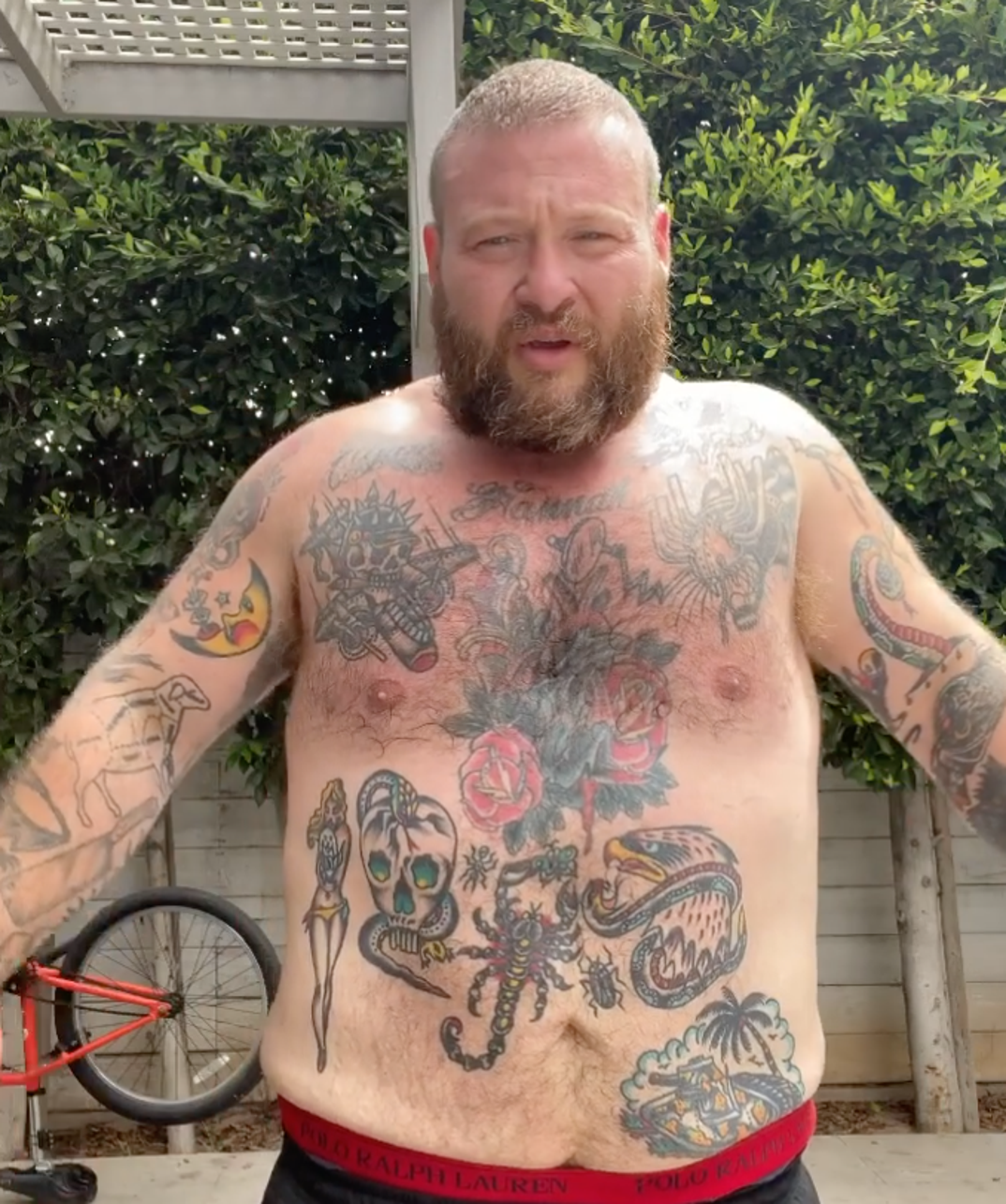 Action Bronson tattoos: tattooed arm during performance