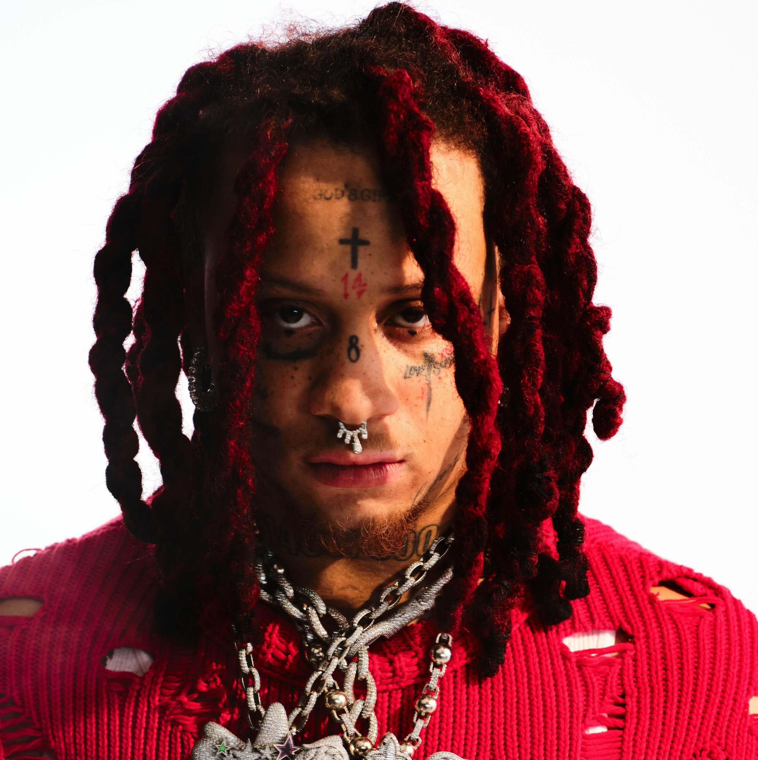 Trippie Redd tattoos: large promotional portrait showing the forehead, eye and neck tattoo groups