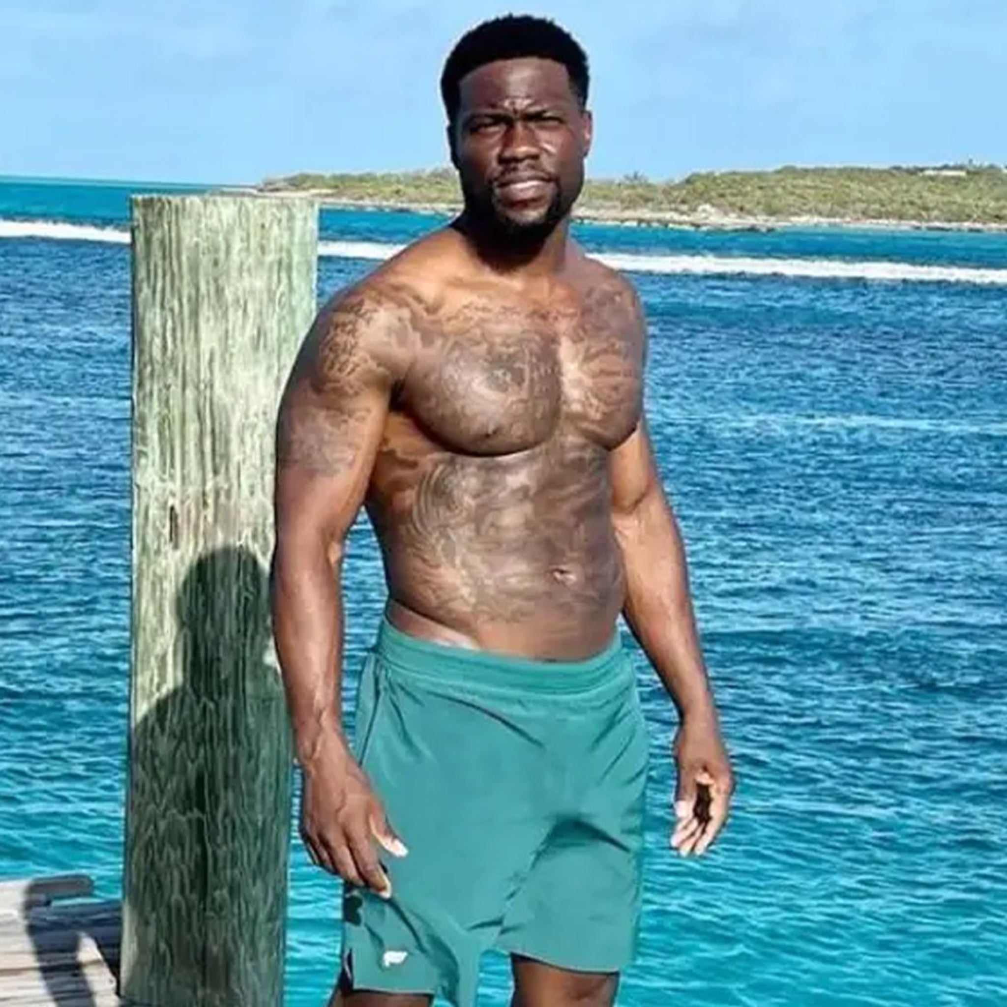 Kevin Hart tattoos: different high-resolution beach photograph showing arms and chest ink