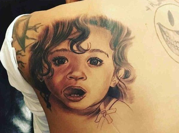 Chris Brown's black-and-gray portrait tattoo of his daughter Royalty on his back