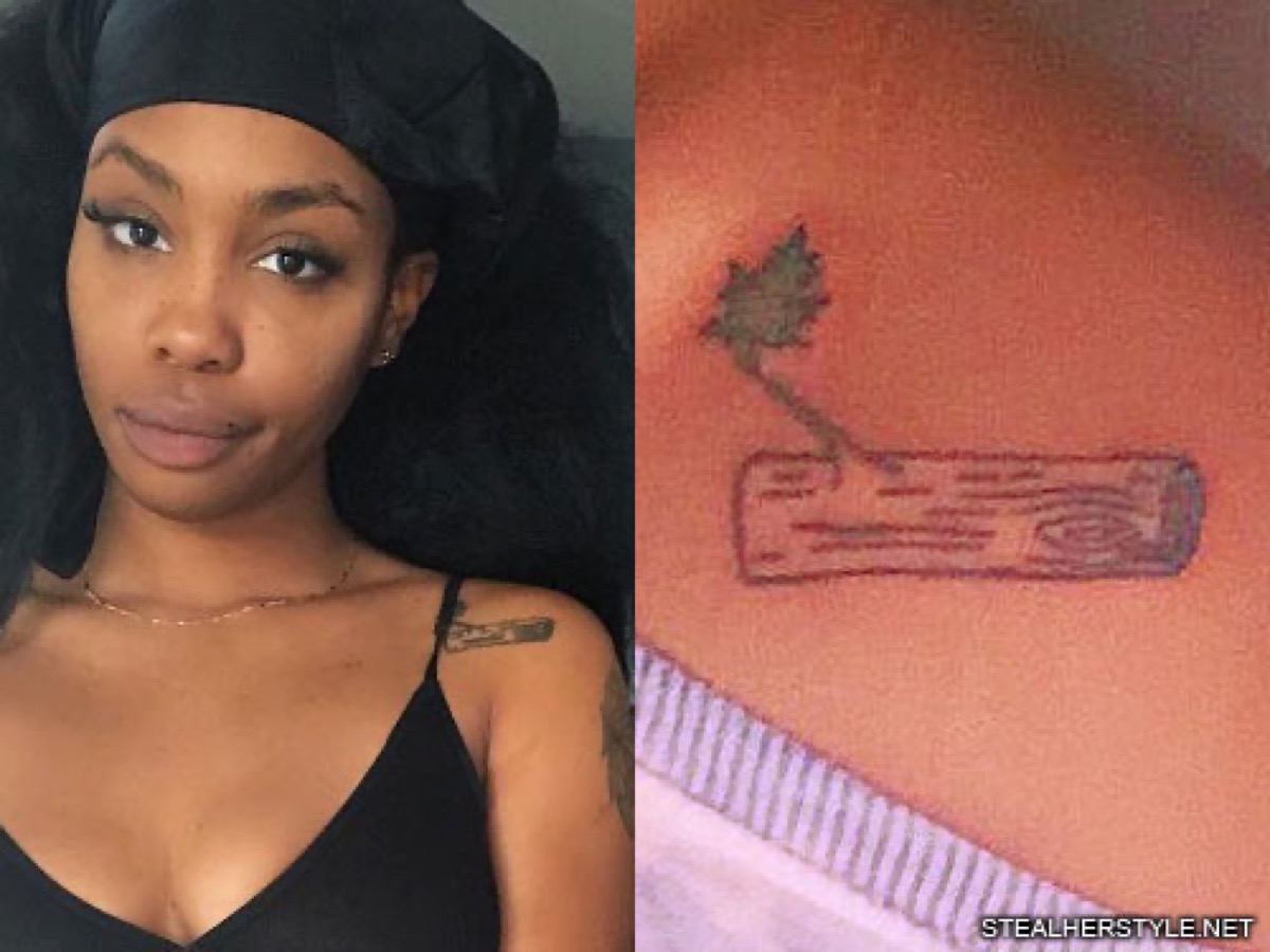 SZA tattoos: clear close-up of SZA’s branch and flower chest tattoo