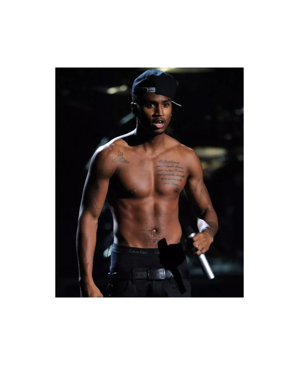 Trey Songz tattoos: Distinct performance photograph where the chest prayer and arm ink are visible