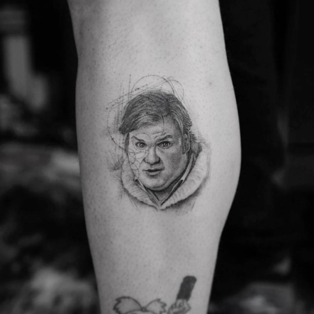 Realistic Chris Farley portrait tattoo on a fan's calf