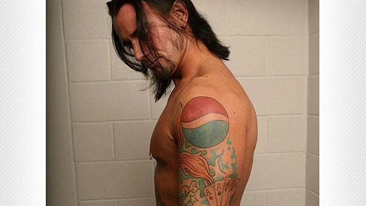 CM Punk tattoos: dark chest skull and Virgin Mary artwork