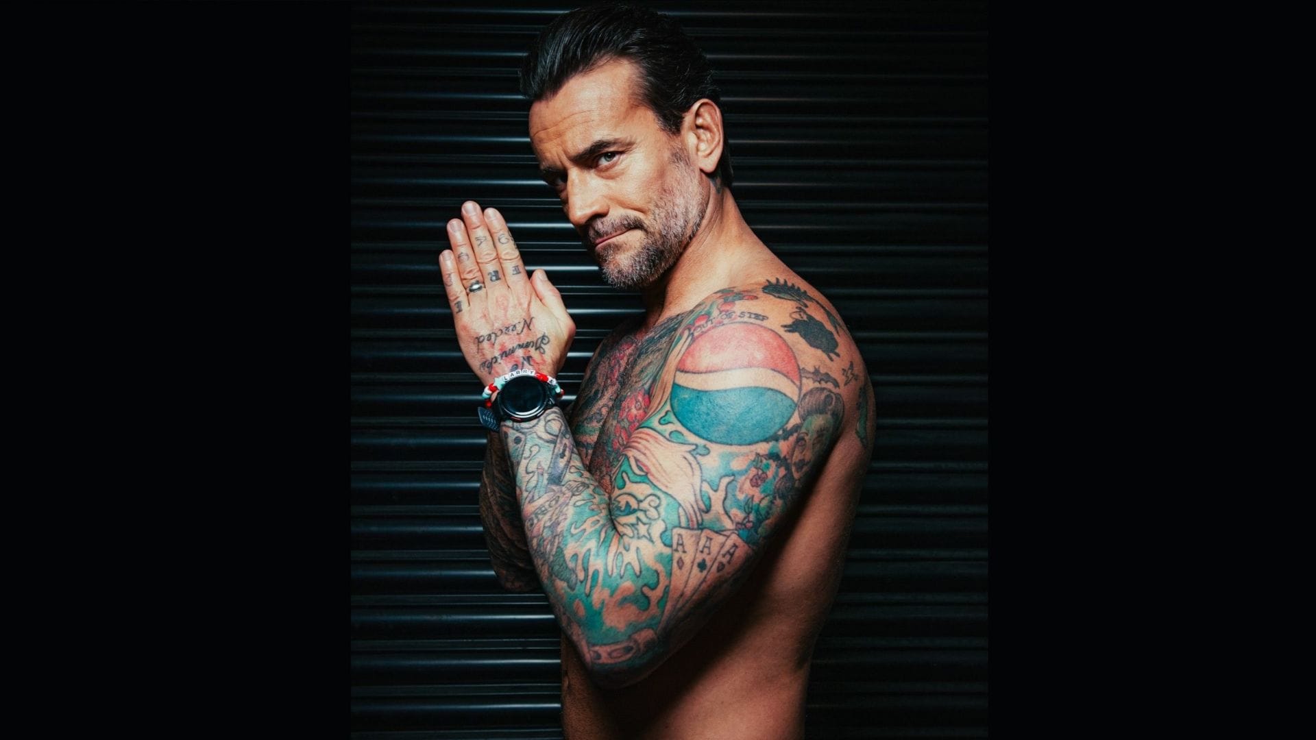 CM Punk tattoos: Pepsi shoulder logo and coloured upper-body tattoos