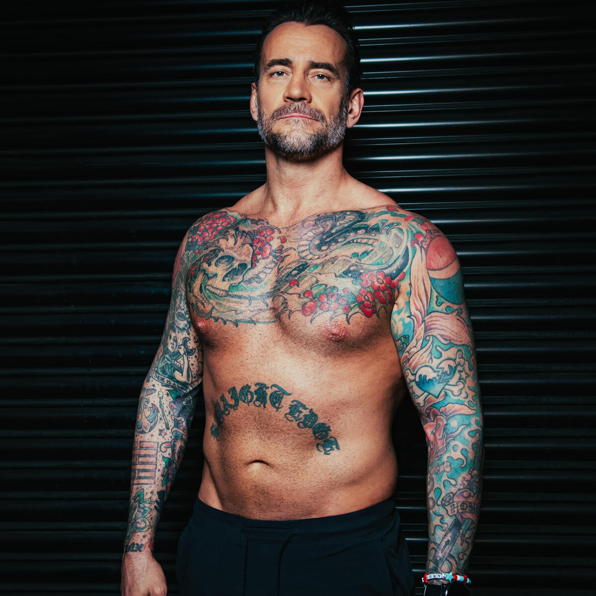 CM Punk tattoos: straight-edge stomach lettering and chest tattoos