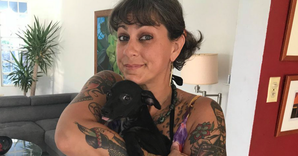 Danielle Colby showing colorful arm and shoulder tattoos