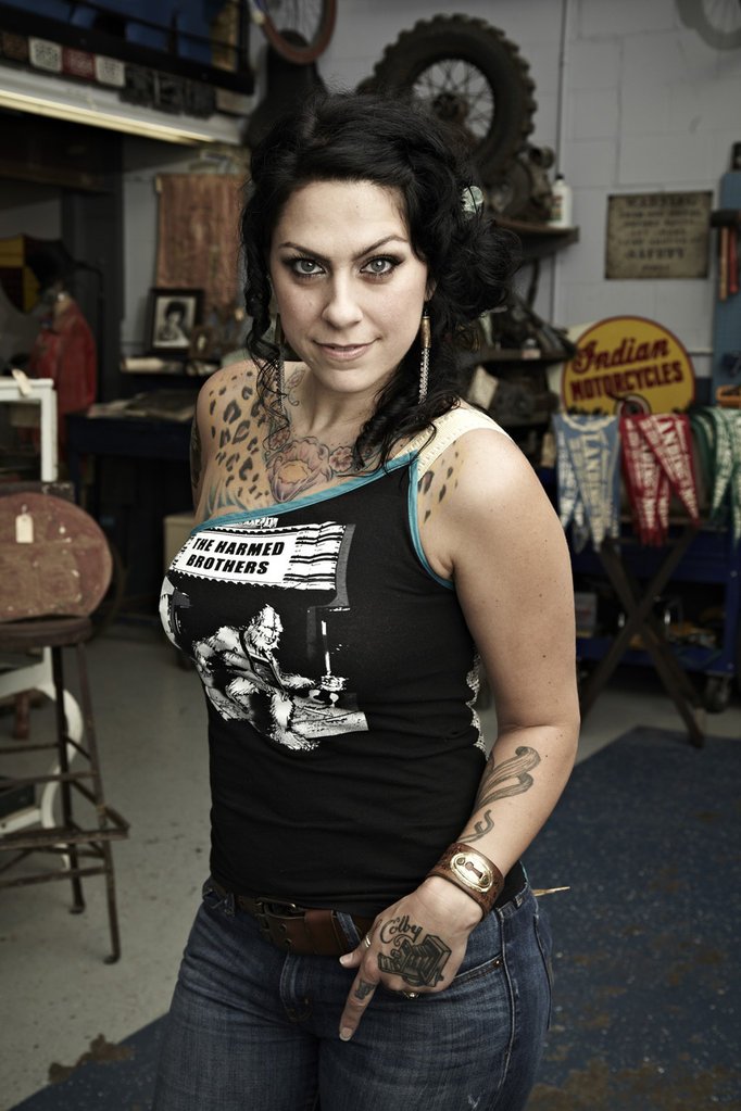 Danielle Colby showing her right-arm tattoo work