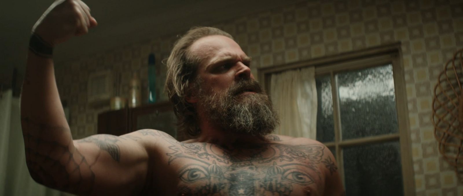 David Harbour Red Guardian chest and arm tattoos
