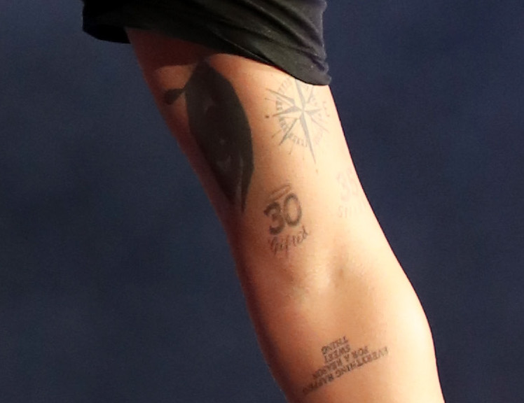 Drake’s left arm showing the 30 and 35 number tattoos