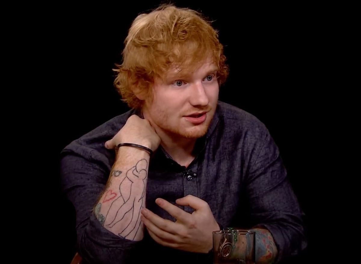 Ed Sheeran showing the Matisse mother and child tattoo on his forearm