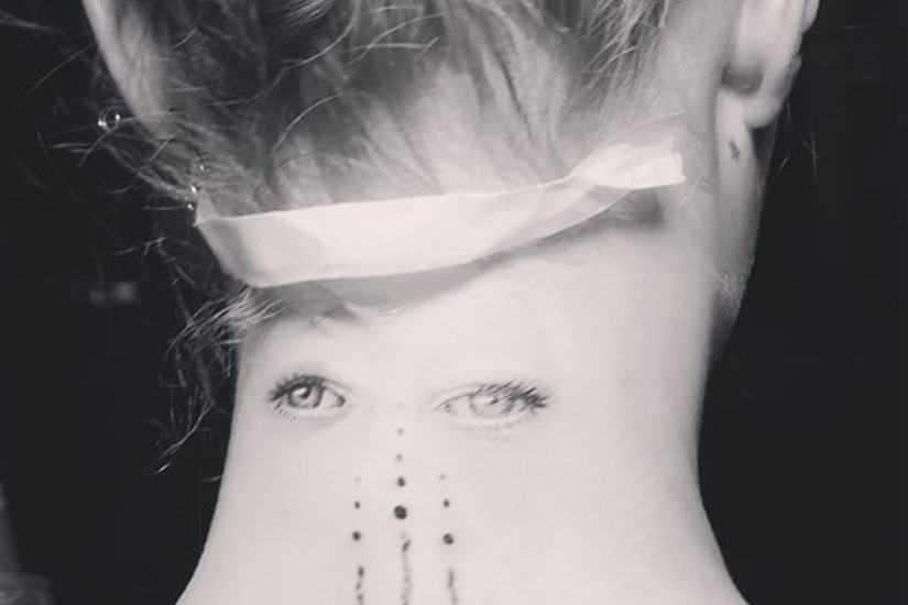 Cara Delevingne eyes tattoo on the back of her neck