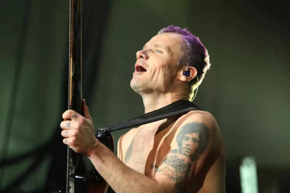 Flea showing his Jimi Hendrix portrait tattoo