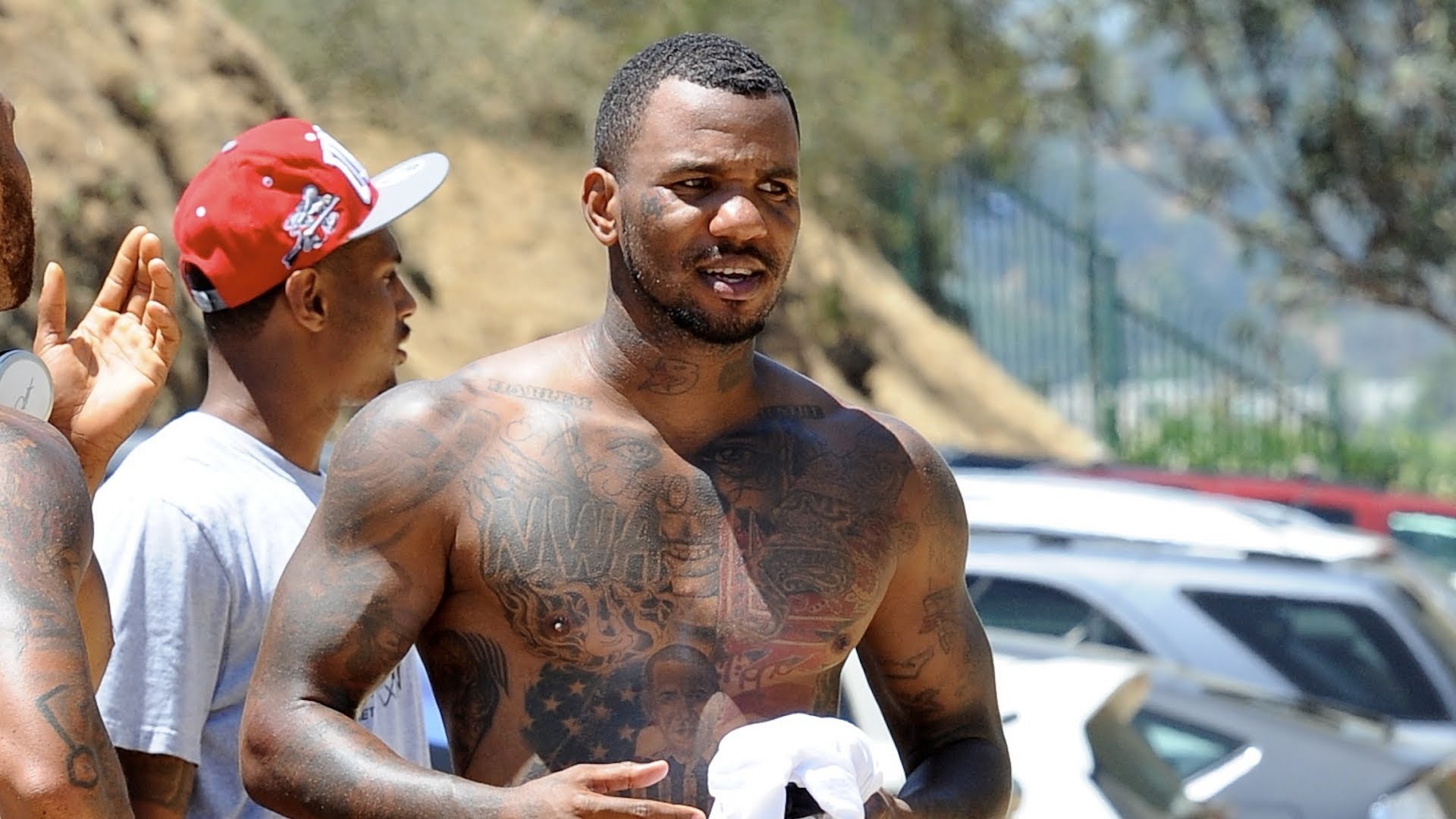 The Game portrait tattoos across his chest and arms