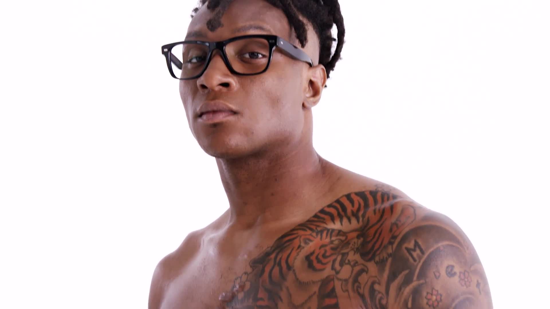 DeAndre Hopkins tattoos: Separate GQ frame showing the tiger chest and Japanese-inspired shoulder work