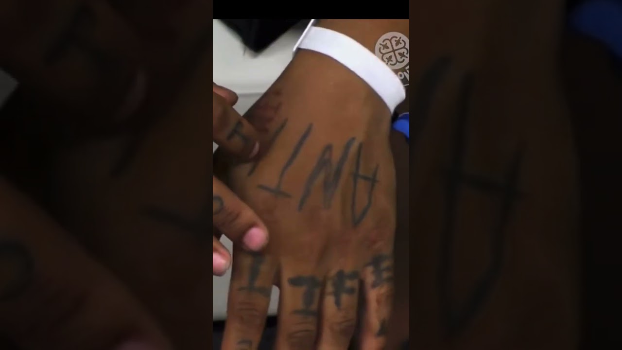 Iman Shumpert tattoos: close-up of the hand and knuckle lettering