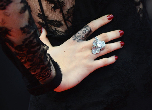 Cara Delevingne showing tattoos on her hand