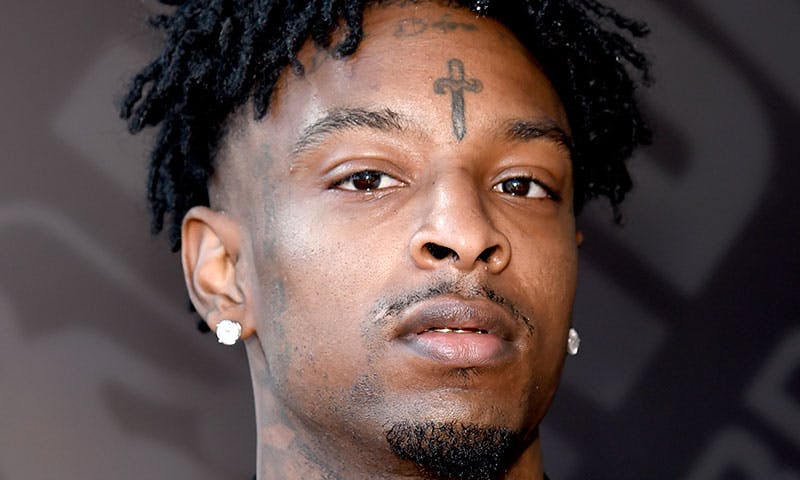 21 Savage portrait showing face and neck tattoos