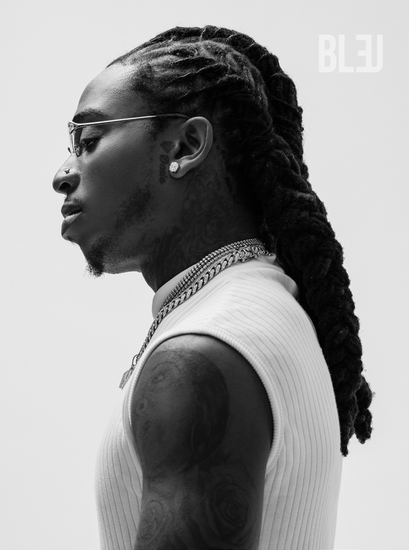 Jacquees showing neck and arm tattoos in a side-profile portrait