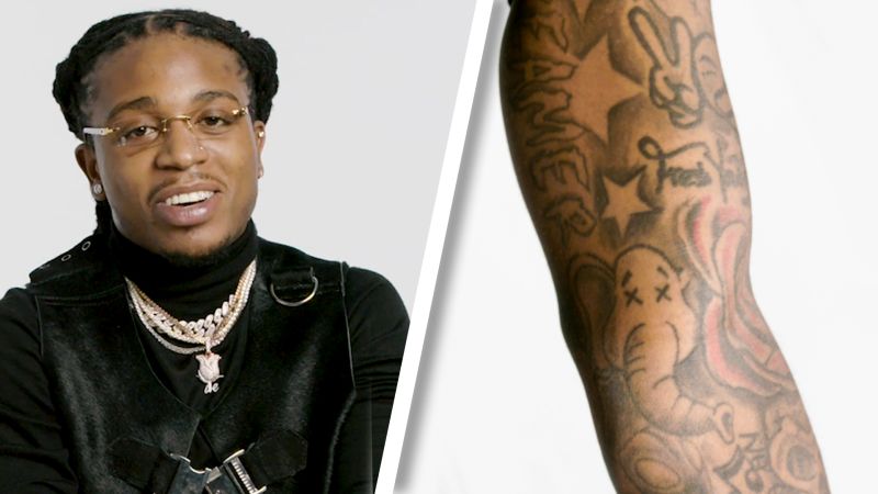 Jacquees showing his Fear God hand tattoo during a tattoo tour