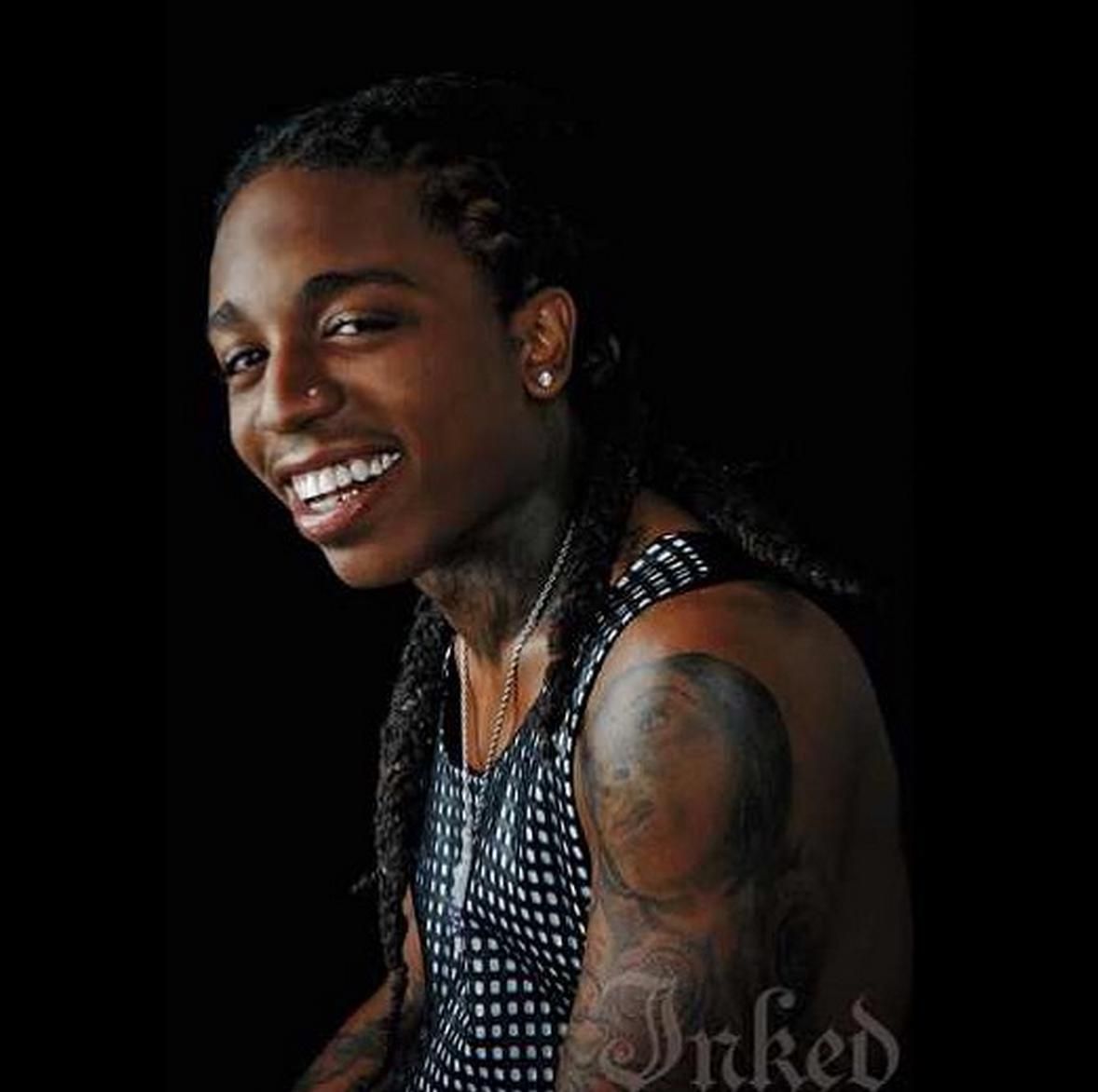 Jacquees with visible family-name and facial tattoos