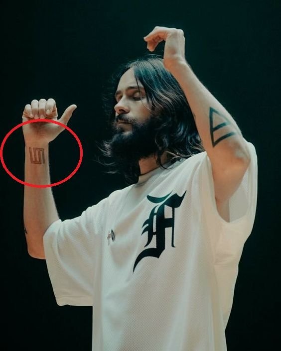 Jared Leto showing forearm triangles and glyphs