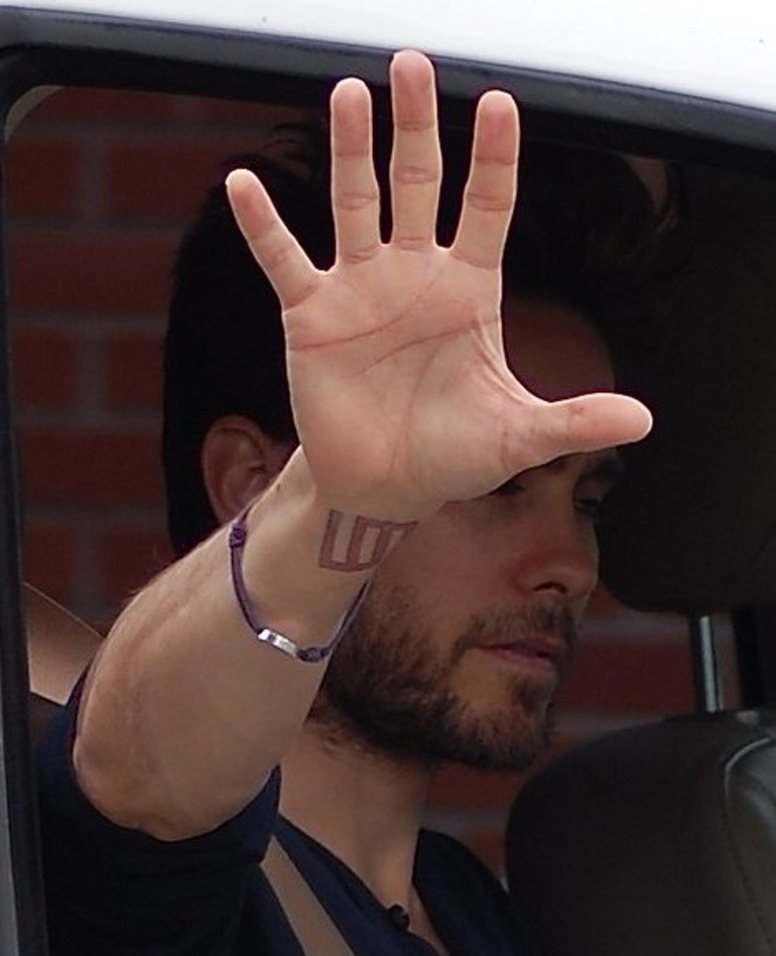 Jared Leto showing the Thirty Seconds to Mars wrist glyph