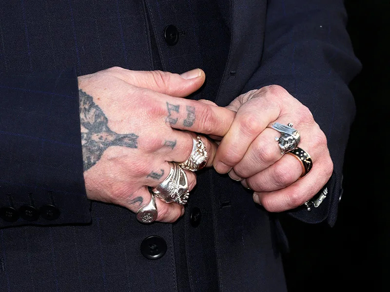 Johnny Depp hand lettering and finger tattoos