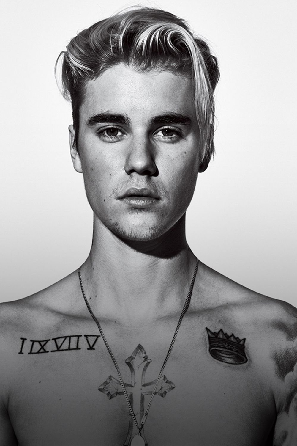 Justin Bieber showing Roman numerals and chest tattoos